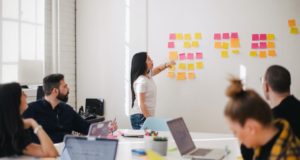 Business People In Board Room Looking At Wall Chart