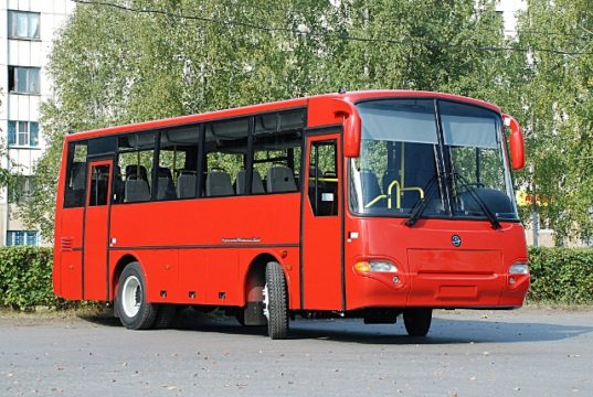 GAZ Buses Bright Red Bus Parked in Font of Trees