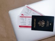 Fees and Fines for Migración Nicaragua US PAssport on Laptop with Tickets