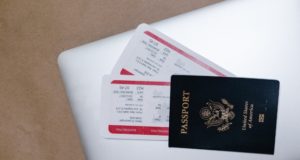 Fees and Fines for Migración Nicaragua US PAssport on Laptop with Tickets