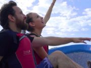 Solentiname Tours Discover Nicaragua Couple on Boat Pointing at Sky