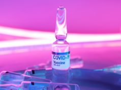 Voluntary Vaccination Program Nicaragua Vial and Syringe Purple Background