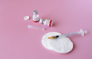 Covid-19 Vaccination Program Needle Swab Vials Pink Background