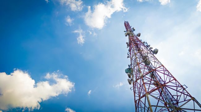 New Telecommunications Law Cell Phone Tower Blue Sky and Clouds